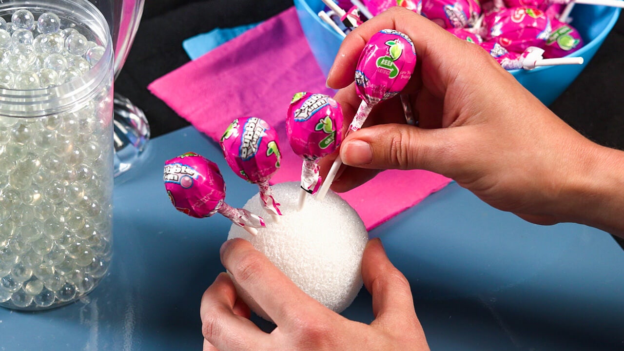 push each lollipop into the styrofoam ball