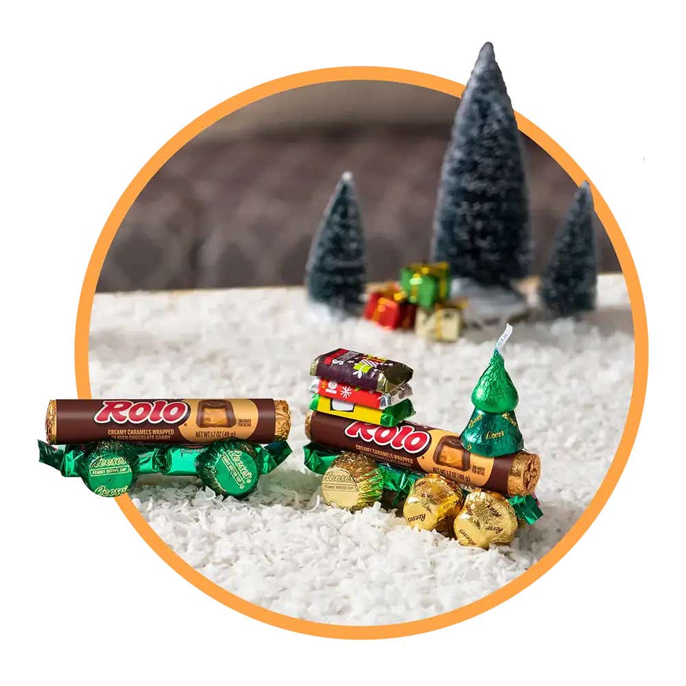 fully decorated rolo candy trains in a winter themed setting
